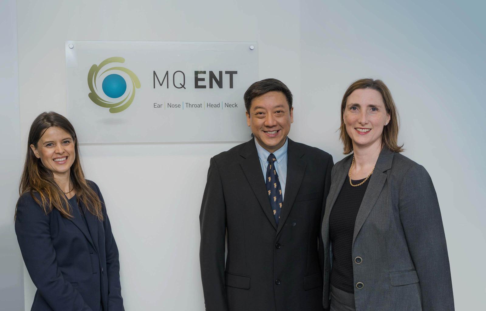 Team-members in front of MQ ENT sign